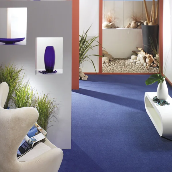 Blue carpet in a seating area adjoining a bathroom