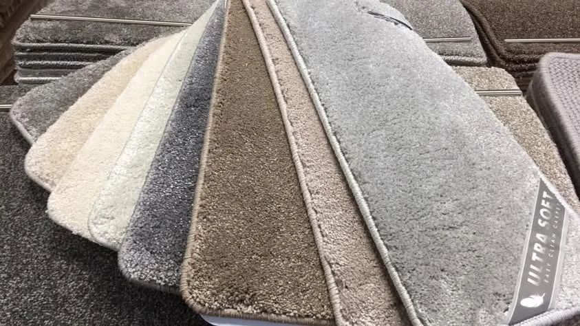 A fan of cream, grey and taupe carpet samples