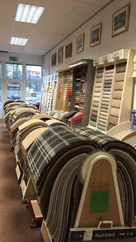 Tall sample stands with tartan, plain and textured carpets in the shop
