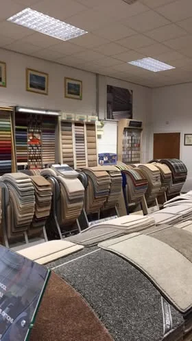 A wide view of the original showroom with rolls and sample stands