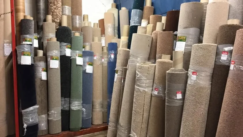 Carpet rolls in shades of beige, cream, blue and grey