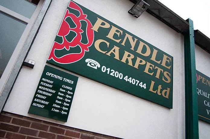 The original bottle-green Pendle Carpets fascia, with gold lettering and red Lancashire rose